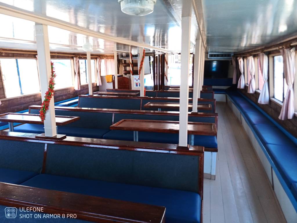 Boat interior with tables and blue seats